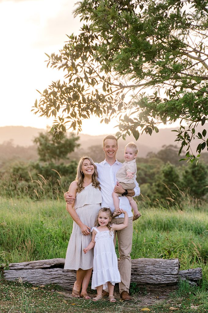 family portraits in a field at sunset